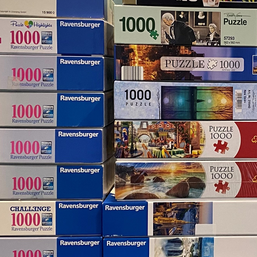 Eine Ansammlung an verschiedenen Puzzlekartons ist zu sehen.